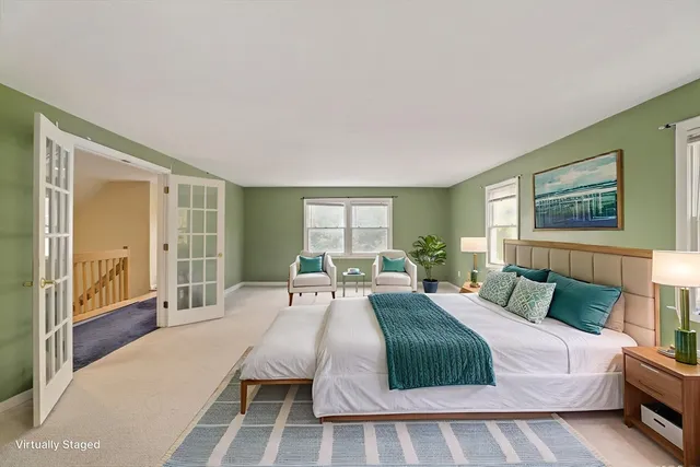 a bedroom with a large bed and a window