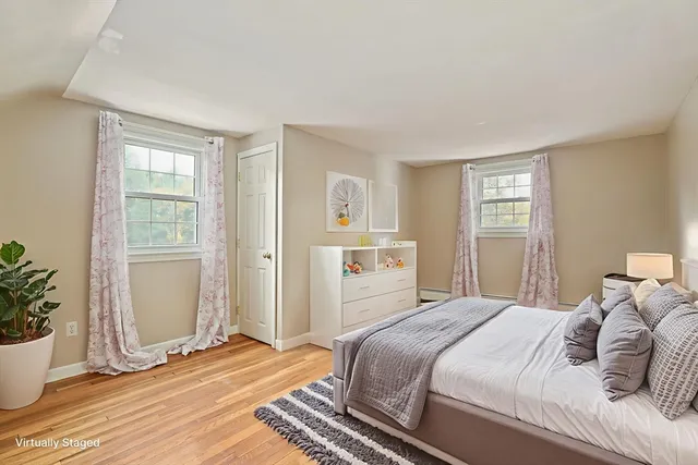 a bedroom with a large bed and a window