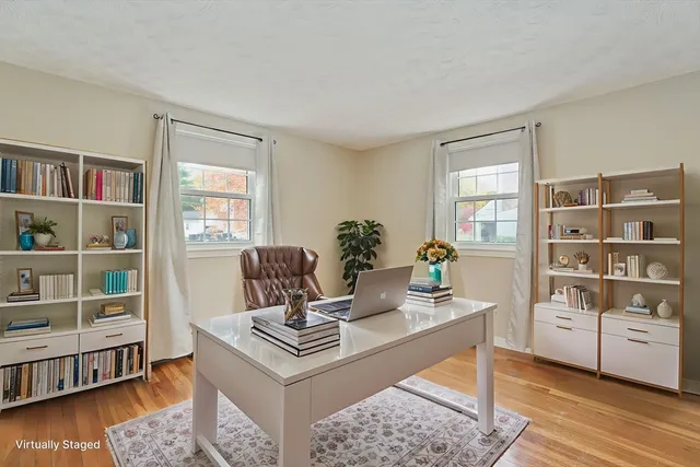 a living room with furniture and a book shelf