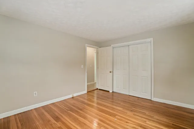 a view of an empty room and wooden floor