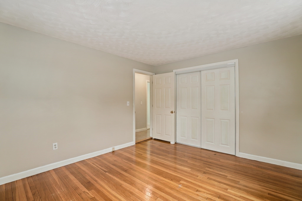 27 Pollard Drive Millis, MA 02054 - Photo 24 of 41 a view of an empty room and wooden floor