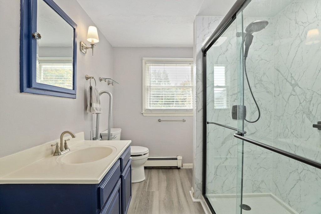 27 Pollard Drive Millis, MA 02054 - Photo 25 of 41 a bathroom with a sink and mirror with toilet