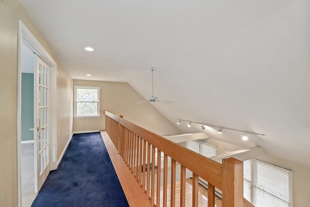 27 Pollard Drive Millis, MA 02054 - Photo 28 of 41 a view of a hallway with wooden floor and staircase