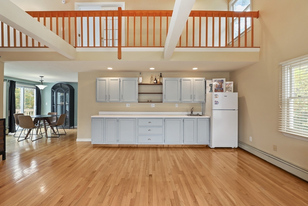 27 Pollard Drive Millis, MA 02054 - Photo 6 of 41 a kitchen with stainless steel appliances kitchen island a refrigerator and a wooden floor