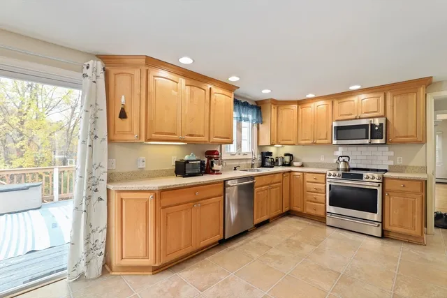 a kitchen with a sink a stove and cabinets