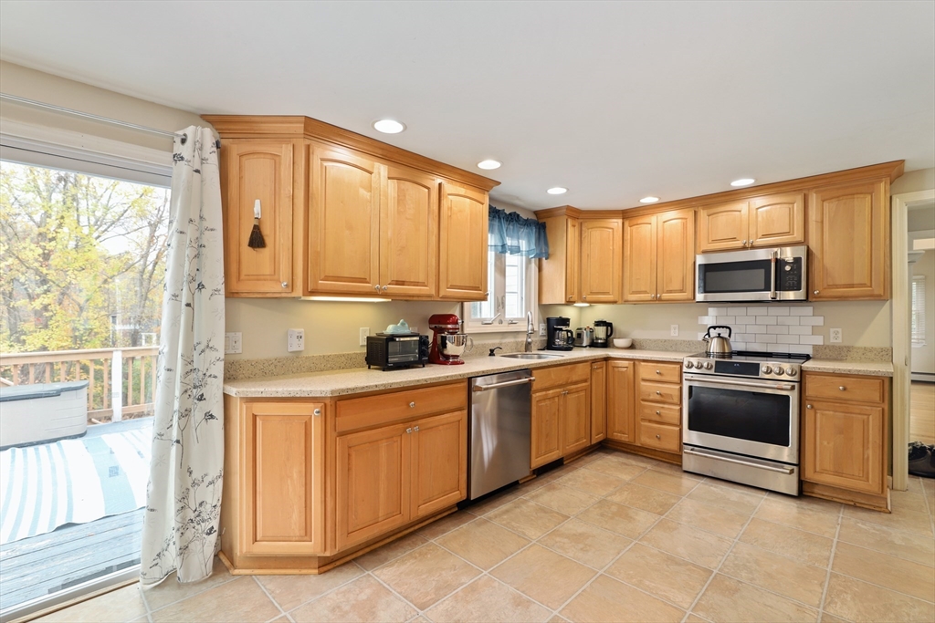27 Pollard Drive Millis, MA 02054 - Photo 8 of 41 a kitchen with a sink a stove and cabinets