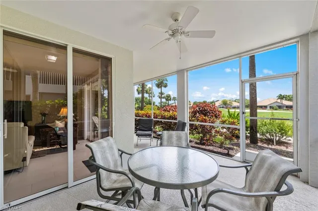 a dining room with furniture floor to ceiling windows and a chandelier
