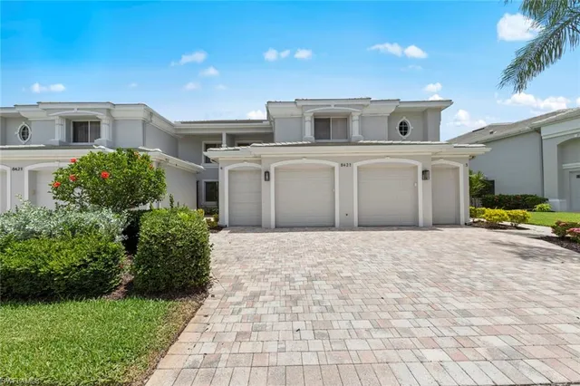 a big house with a big yard and large trees