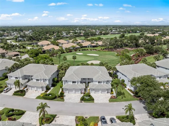 an aerial view of a house with a garden and lake view
