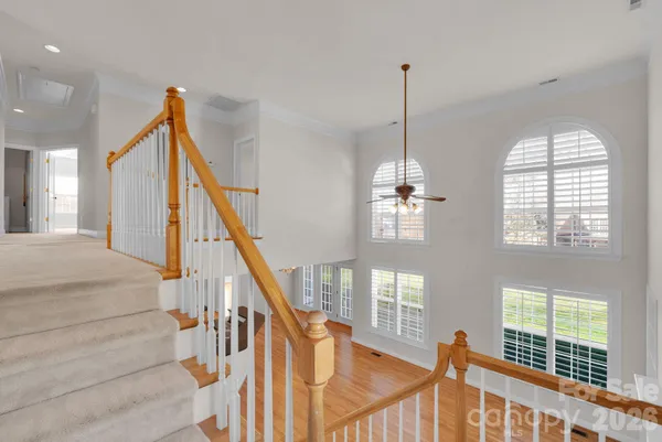 a view of a hallway with two windows
