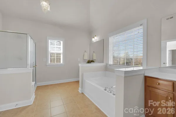 a bathroom with a tub sink and window