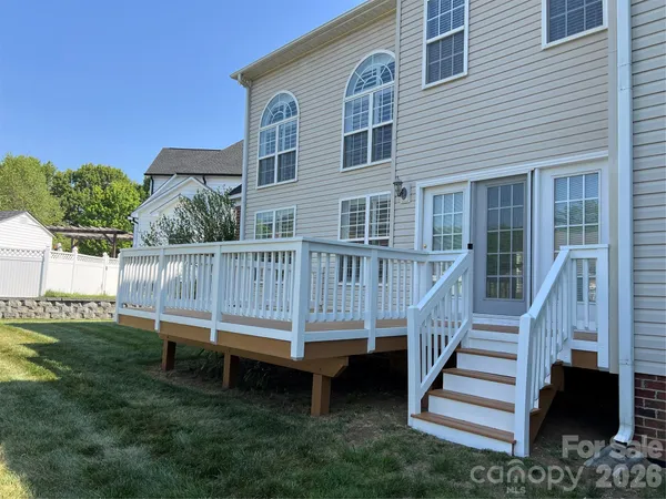 a view of a terrace with wooden floor and fence