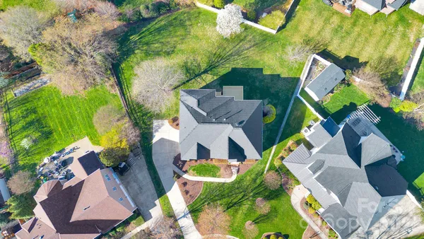 an aerial view of a house with swimming pool and garden