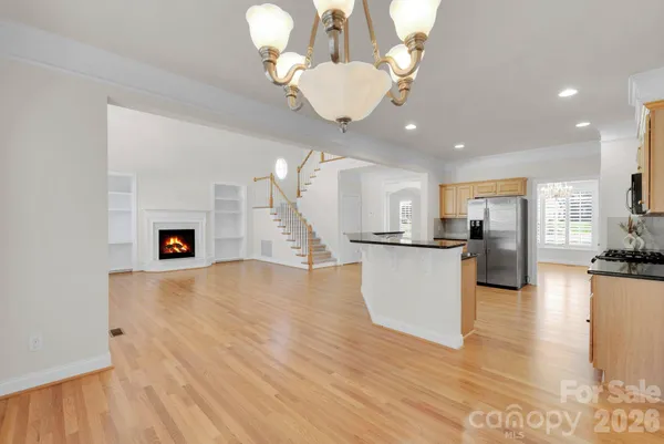 a view of a living room and kitchen with wooden floor