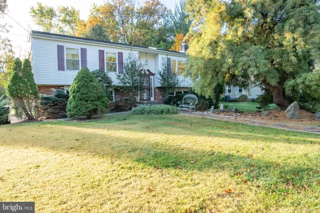 a view of a house with pool and a yard