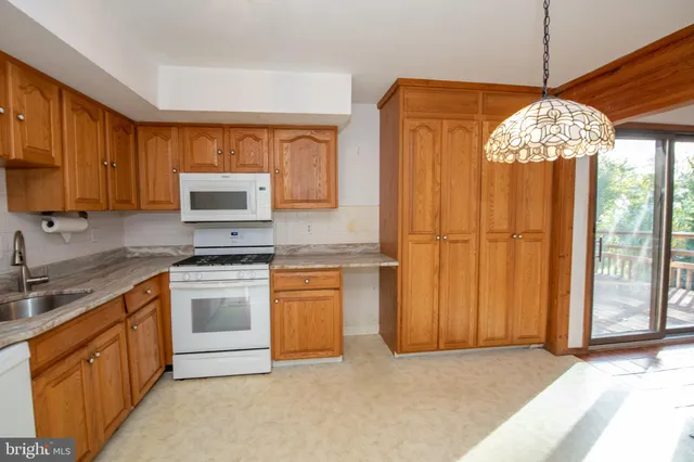 a kitchen with stainless steel appliances granite countertop a stove a sink dishwasher and a refrigerator