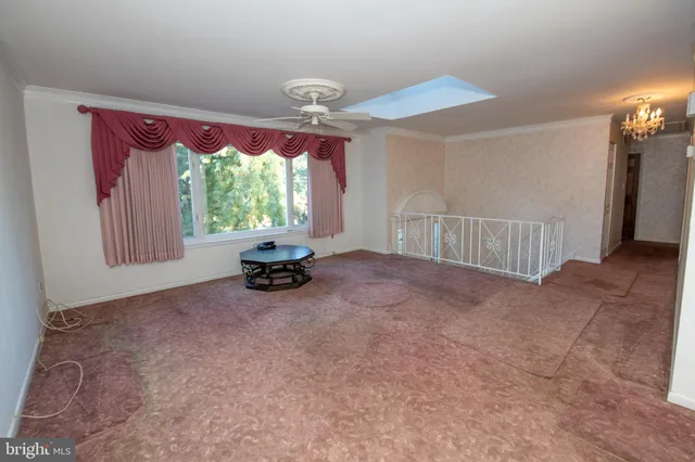 a view of an empty room with a fireplace and a large window