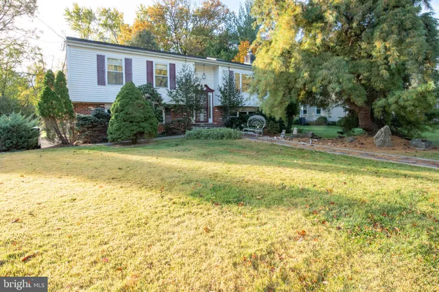 a view of a house with pool and a yard