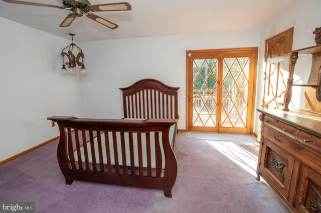 a view of a hallway with a window and dresser