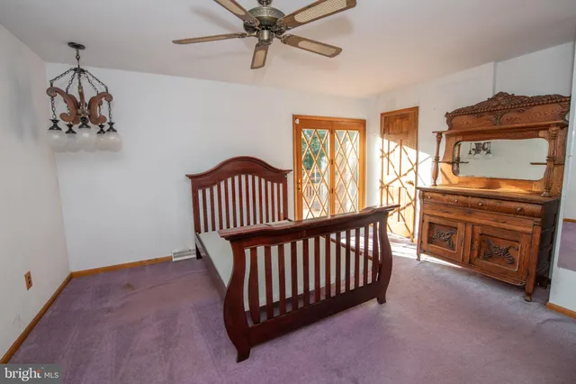 a view of a livingroom with furniture a ceiling fan and wooden floor