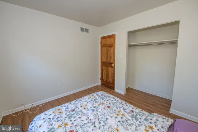 a view of an empty room with a fireplace and a window