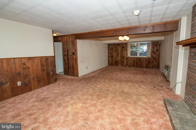 a view of a livingroom with furniture and a fireplace