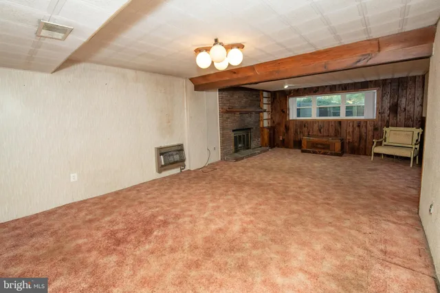 a view of an empty room with a fireplace