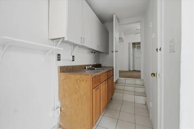 a utility room with cabinets washer and dryer
