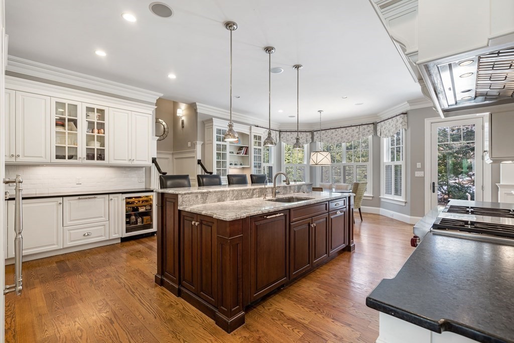55 Edmunds Road Wellesley, MA 02481 - Photo 15 of 40 a large kitchen with stainless steel appliances granite countertop a stove and a wooden floors