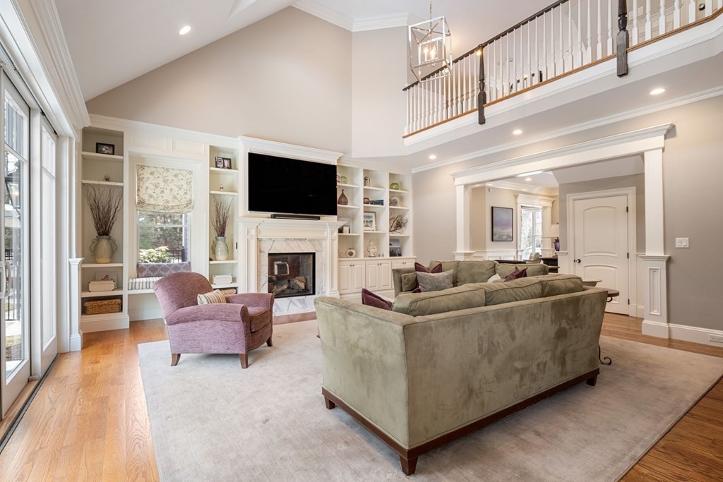 55 Edmunds Road Wellesley, MA 02481 - Photo 20 of 40 a living room with furniture a flat screen tv and a fireplace