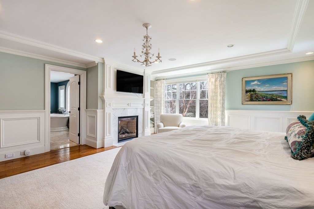 55 Edmunds Road Wellesley, MA 02481 - Photo 24 of 40 a large bedroom with a bed and a fireplace