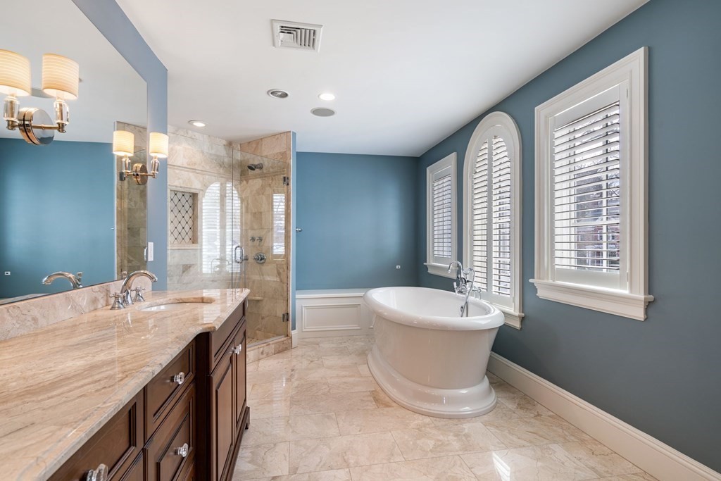 55 Edmunds Road Wellesley, MA 02481 - Photo 25 of 40 a spacious bathroom with a double vanity sink a mirror and a bathtub