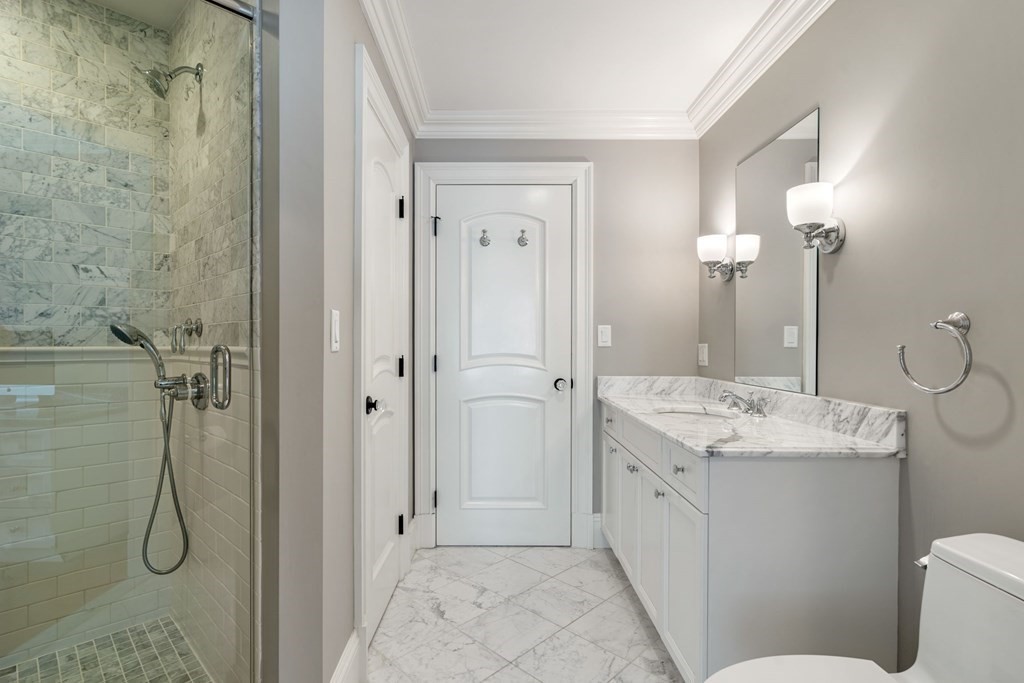 55 Edmunds Road Wellesley, MA 02481 - Photo 27 of 40 a bathroom with a double vanity sink mirror and toilet