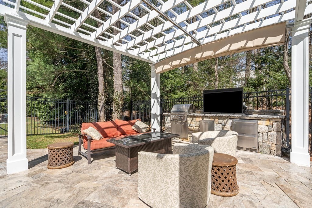 55 Edmunds Road Wellesley, MA 02481 - Photo 35 of 40 a outdoor space with the couches and dining table with the garden view