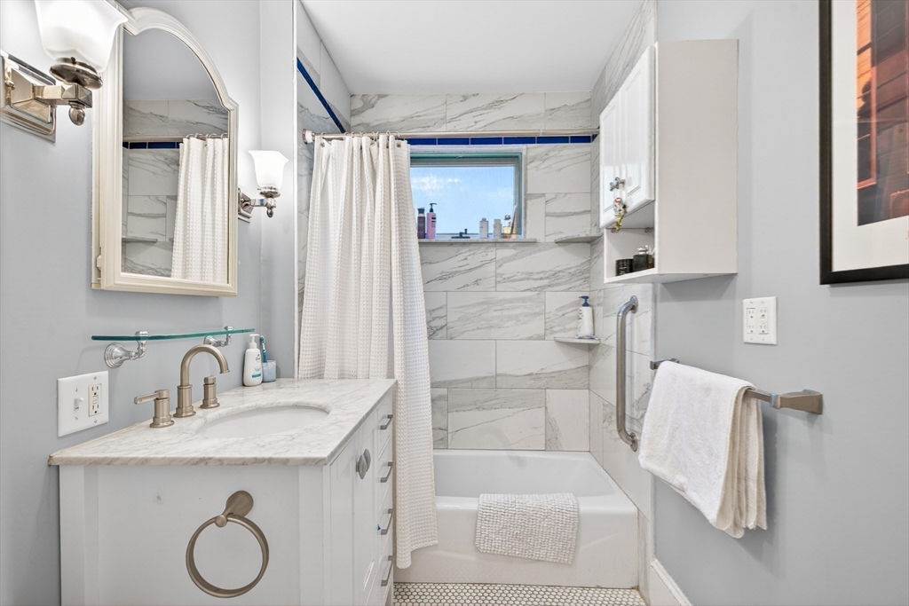 76-78 Lewis Road Belmont, MA 02478 - Photo 9 of 36 a bathroom with a granite countertop sink a toilet and shower