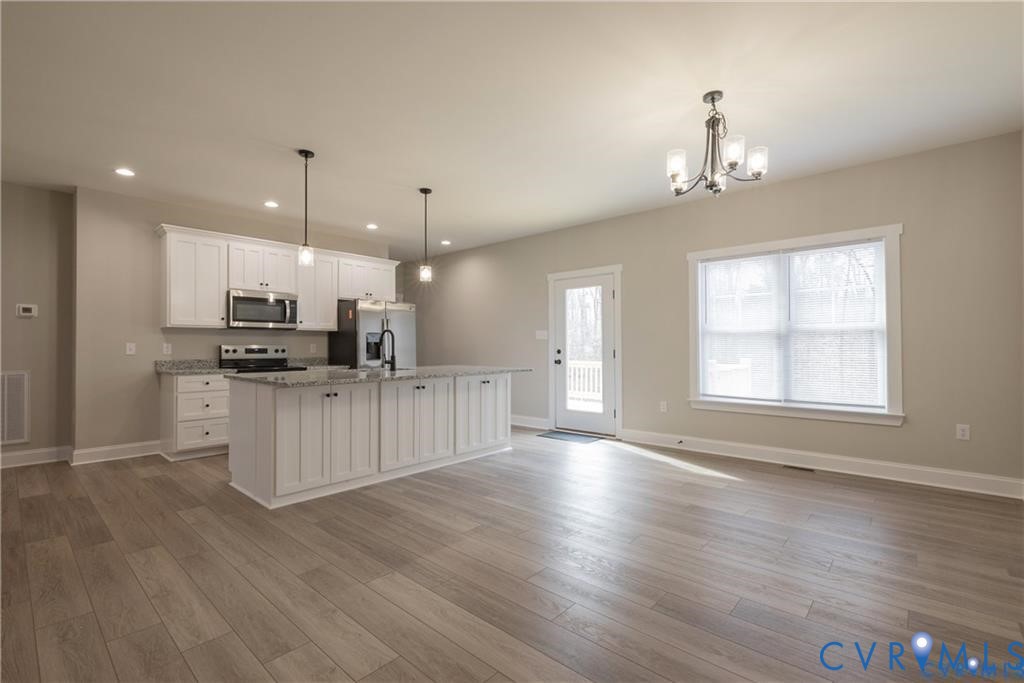 2223 Ridge Road Arvonia, VA 23004 - Photo 11 of 32 Open concept living area with wood-finish flooring