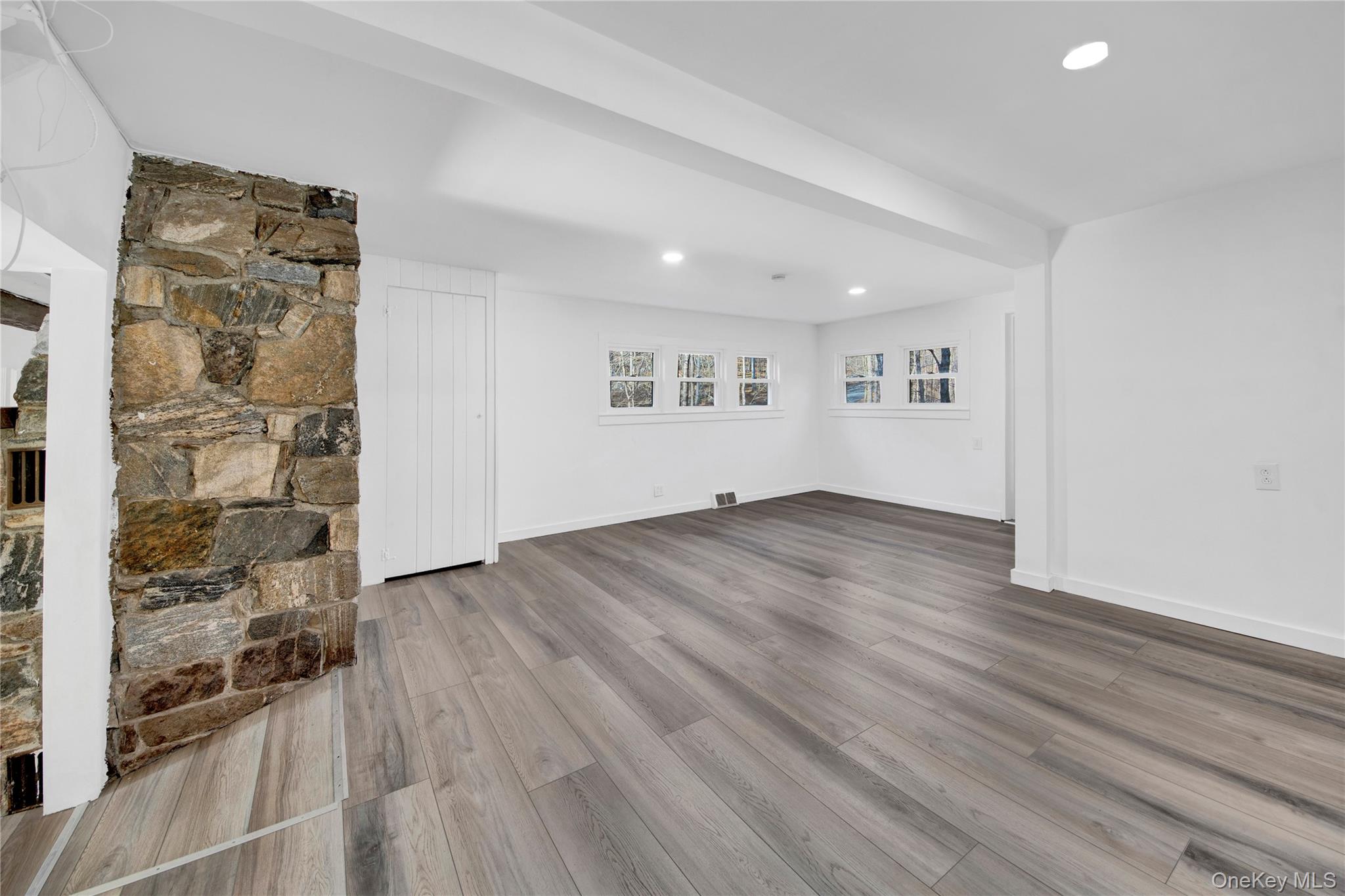 690 Gipsy Trail Road Carmel, NY 10512 - Photo 11 of 35 an empty room with wooden floor and windows
