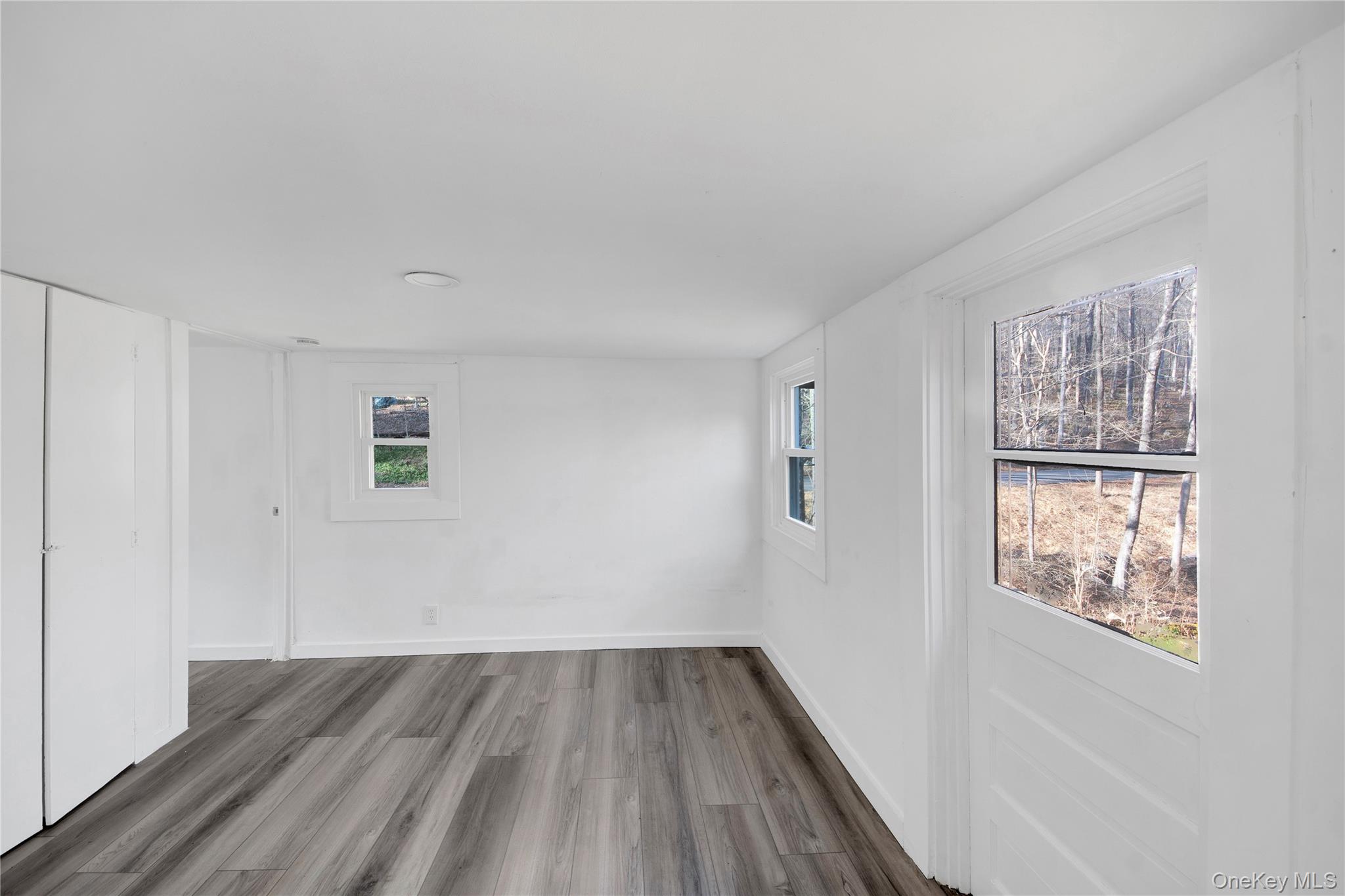 690 Gipsy Trail Road Carmel, NY 10512 - Photo 12 of 35 a view of an empty room with wooden floor and a window
