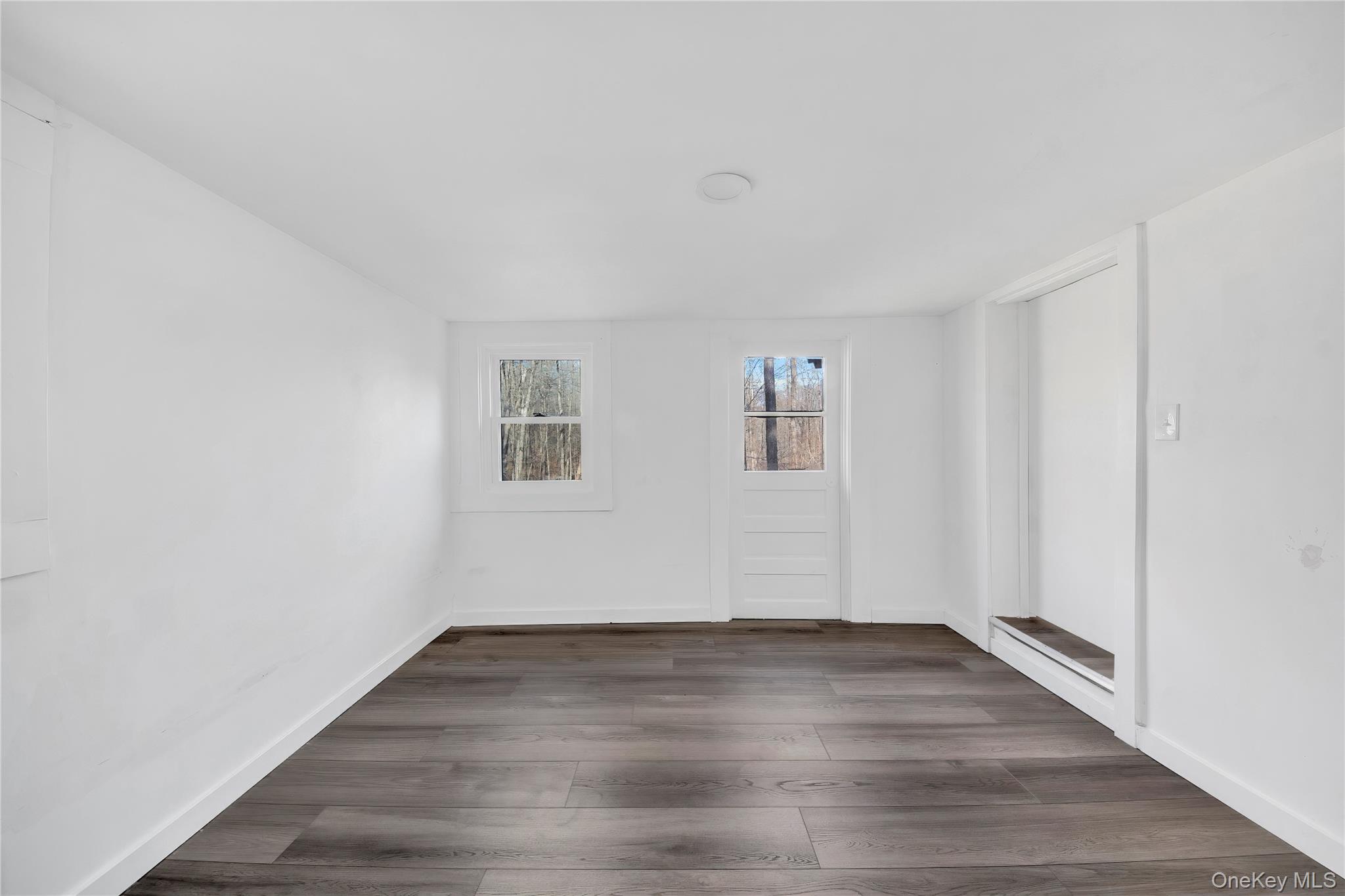690 Gipsy Trail Road Carmel, NY 10512 - Photo 13 of 35 an empty room with wooden floor and windows