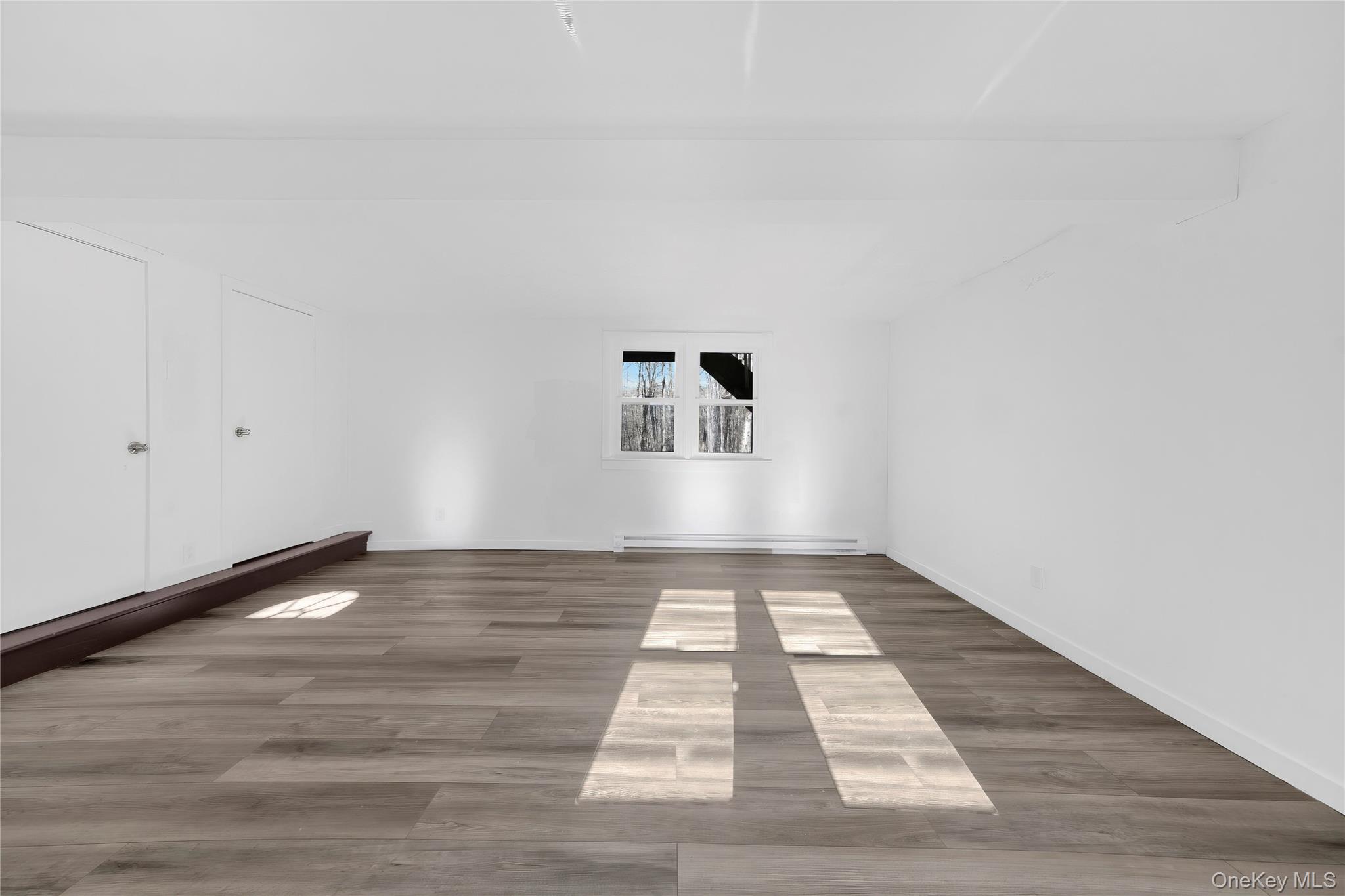 690 Gipsy Trail Road Carmel, NY 10512 - Photo 18 of 35 Empty room featuring wood finished floors and baseboard heating