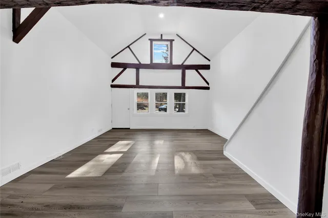 a white toilet sitting next to a white sink and vanity