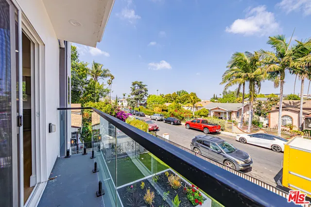 a view of a balcony with flower plants