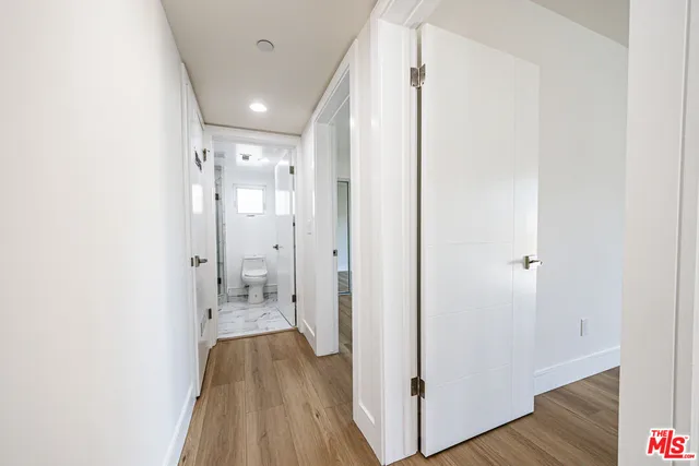 a view of hallway with wooden floor