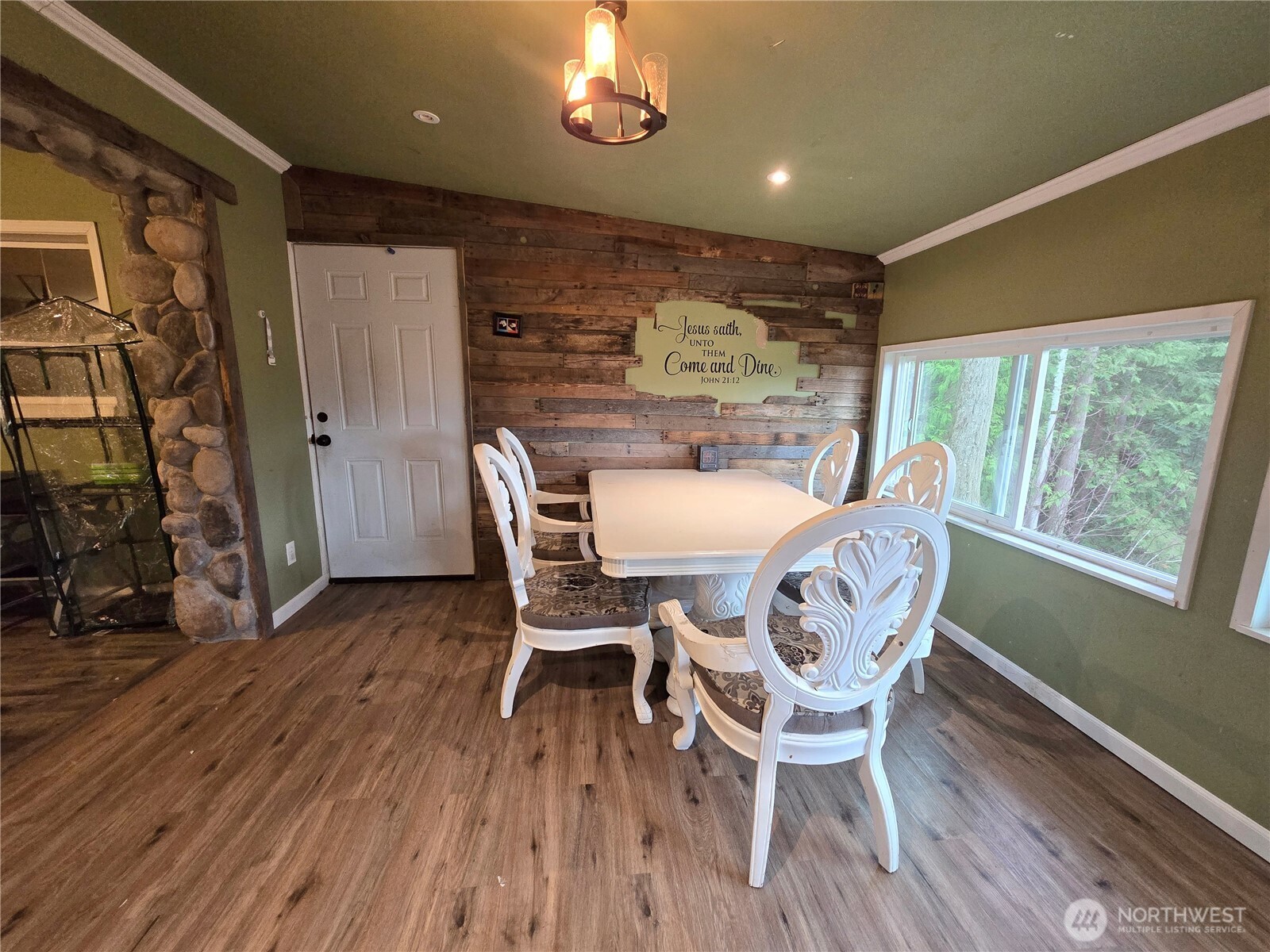 276261 Highway 101 Sequim, WA 98382 - Photo 17 of 33 a view of a dining room with furniture window and wooden floor