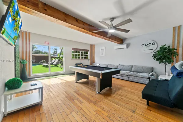 a living room with furniture and a floor to ceiling window