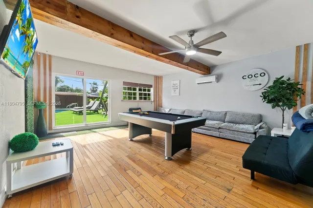a living room with furniture and a floor to ceiling window