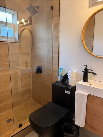 a bathroom with a sink toilet and shower