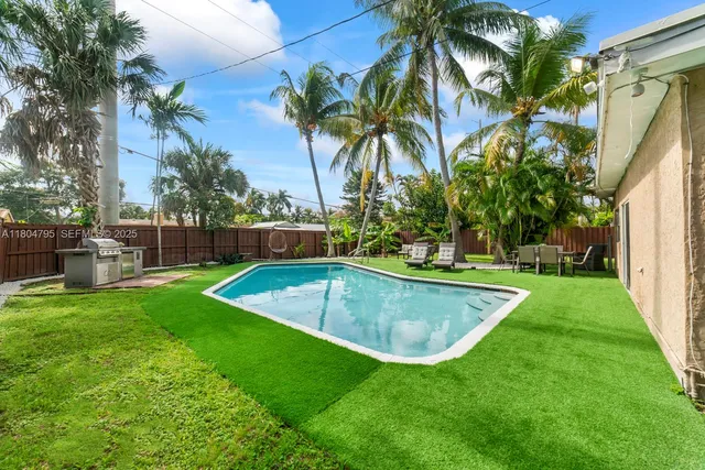 a view of a backyard with swimming pool
