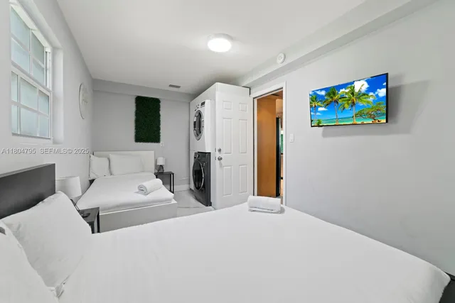 a bed room with a bed mirror and a flat screen tv