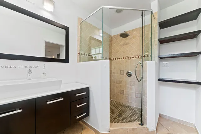 a bathroom with a shower and a sink